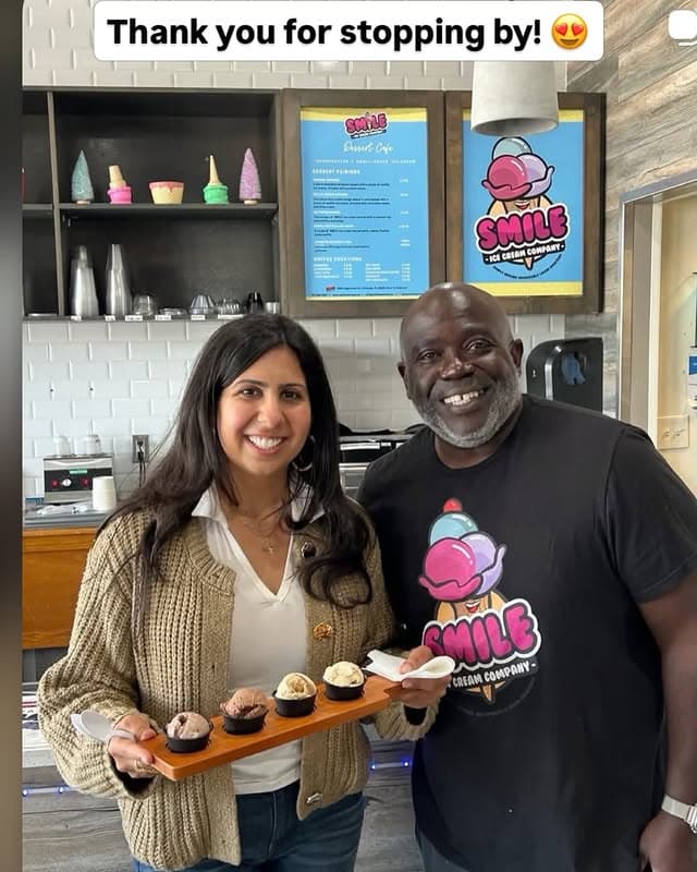 Glen R. Providence, Chief Smile Officer of Smile Ice Cream, greeting a customer with a sample flight