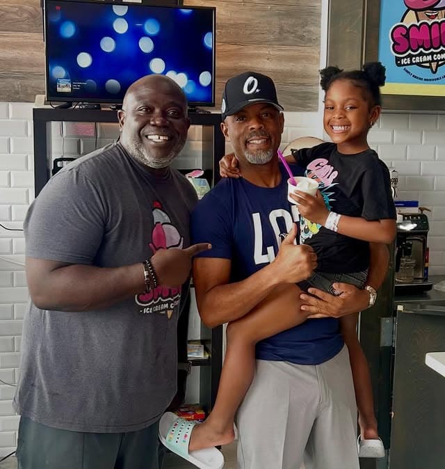 Glen with neighbors and a kiddo inside the shop